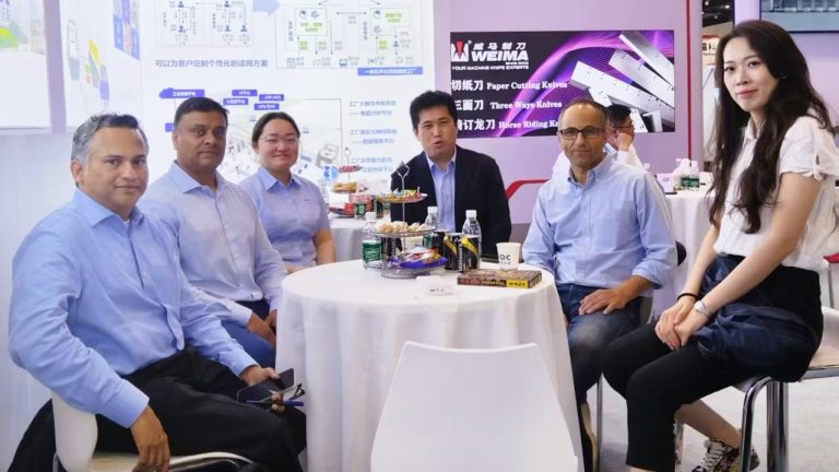 WISPRINT International Team and agents sat at a table at a show in China